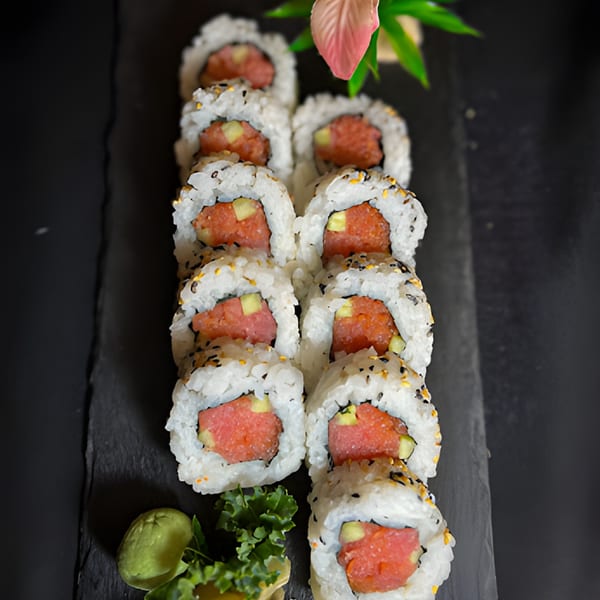 Siam Orchid Cocoa Beach's spicy tuna rolls with wasabi and garnish on a dark slate.